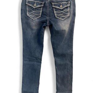 Blue skinny jeans with white stitching and embellished back pockets.